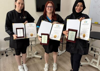 Cat groomer Kimberley receiving certification after advanced grooming training in Singapore